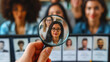 © OMGAi - Magnifying Glass Selecting Candidate from Lineup. A magnifying glass focusing on a selected female candidate amongst a diverse lineup of professionals. HR Human Resources Targeting Concept in Business
