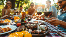 Group Of Happy Friends Having A Barbecue Meal Sitting At A Table Outdoors. Family Enjoying A Meal Together In The Garden Or Backyard Of Their Home. Concept Meeting Friends, Food And Good Time. 