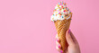 Hand Holding a Vanilla Ice Cream Cone with Sprinkles
