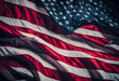 Close-up of the American flag with dramatic lighting and shadows, highlighting the stars and stripes with a sense of depth and texture.