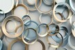 Abstract background with differently sized overlapping metal rings in light blue and beige colors, creating an elegant pattern