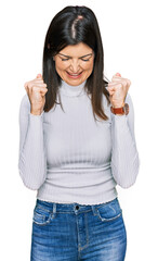 Poster - Beautiful brunette woman wearing casual clothes excited for success with arms raised and eyes closed celebrating victory smiling. winner concept.