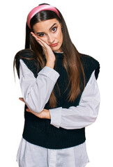 Canvas Print - Young beautiful woman wearing casual white shirt thinking looking tired and bored with depression problems with crossed arms.