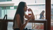 Relaxed girl drinking lemonade in restaurant close up. Asian woman tasting
