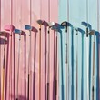 Vibrant Array of Golf Clubs Against Pastel Pink and Blue Background in Daylight