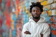 Energetic Black teenager in white hoodie standing against vibrant wall. Concept Fashion Photography, Street Style, Vibrant Colors, Urban Background, Modern Teen Style