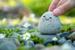© LimeSky - Practicing mental health by balancing body mind soul and spirit with a natural pebble stone and smiling face cartoon in a flower garden