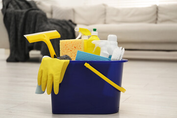 Canvas Print - Different cleaning supplies in bucket on floor at home