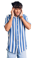 Poster - Young hispanic man wearing casual clothes with hand on head, headache because stress. suffering migraine.