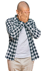 Canvas Print - Hispanic adult man wearing casual clothes with sad expression covering face with hands while crying. depression concept.