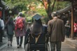 Parents next to a female graduate in a wheelchair, dressed in their symbolic gown and cap. Graduation ceremony.	 Concept inclusivity. 