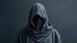 A person in a hoodie standing in front of a dark background. Suitable for mystery or urban themes