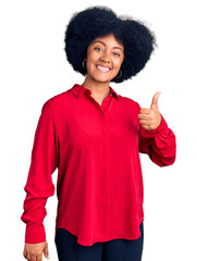 Sticker - Young african american girl wearing casual clothes doing happy thumbs up gesture with hand. approving expression looking at the camera showing success.