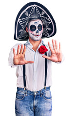 Poster - Man wearing day of the dead costume over background doing stop gesture with hands palms, angry and frustration expression