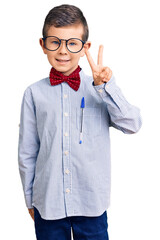 Sticker - Cute blond kid wearing nerd bow tie and glasses smiling with happy face winking at the camera doing victory sign. number two.