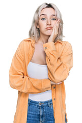 Sticker - Young blonde girl wearing casual clothes thinking looking tired and bored with depression problems with crossed arms.