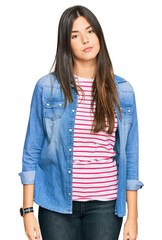 Canvas Print - Young brunette woman wearing casual clothes looking sleepy and tired, exhausted for fatigue and hangover, lazy eyes in the morning.