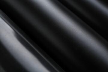 Canvas Print - Energy drinks in black cans as background, closeup