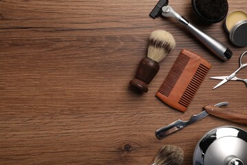 Wall Mural - Moustache and beard styling tools on wooden background, flat lay. Space for text