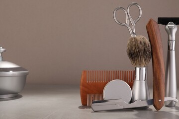 Wall Mural - Moustache and beard styling tools on grey table. Space for text