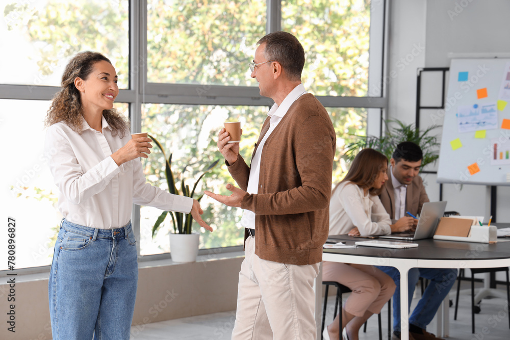 Business people drinking coffee in office