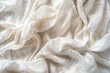 Crushed linen canvas in white handmade from natural cotton fabric provides an organic top view background with an eco friendly textured appearance