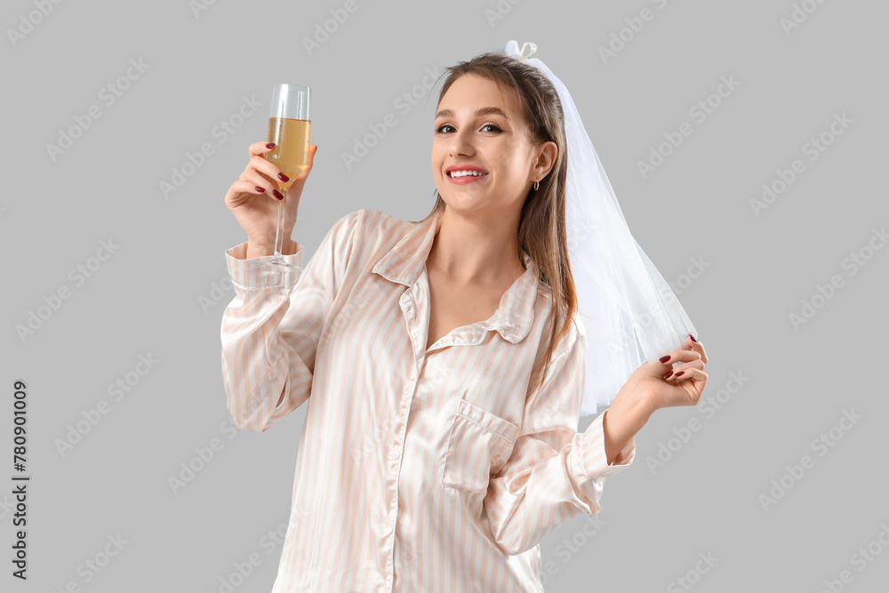 Happy bride in pajamas with champagne on light background. Hen Party