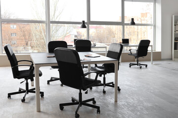 Poster - Interior of stylish conference hall with tables, laptops, window and armchairs