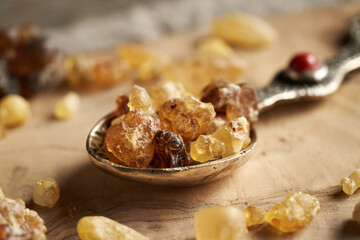 Wall Mural - Frankincense resin crystals on a metal spoon on a table