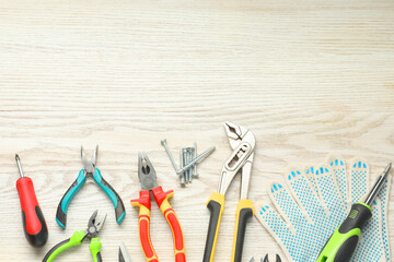 Wall Mural - Different pliers, screwdrivers and other repair tools on wooden table, flat lay. Space for text