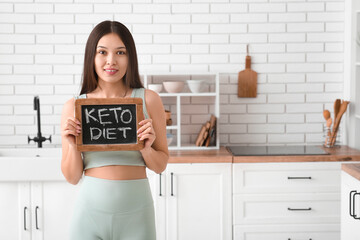 Poster - Beautiful young happy Asian woman holding chalkboard with text KETO DIET at home