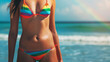 Rainbow bikini on beautiful girl with sea in the background. Concept for bikini day and summer vacation.