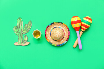 Poster - Maracas, paper cactus, decorative sombrero hat and shot of tequila on green background