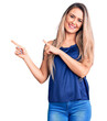 © Krakenimages.com - Young beautiful blonde woman wearing casual sleeveless t-shirt smiling and looking at the camera pointing with two hands and fingers to the side.