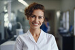 © spyrakot - Waist-up portrait of a smiling dentist woman in a dental clinic