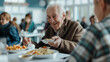 Realistic photo, elderly, white man, very happy, seated eating plate of food, Side view, white table, HIGH SCHOOL CAFETERIA FULL OF PEOPLE. The tone is clear , contrasts with the white blue background