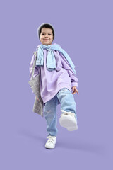 Wall Mural - Cute little Asian boy in adult clothes with bag on lilac background