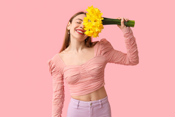 Sticker - Happy young woman with bouquet of beautiful daffodil flowers on pink background