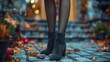 An image of a woman wearing suede boots on high heels with black stockings