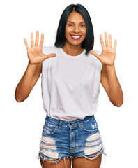 Wall Mural - Young african american woman wearing casual clothes showing and pointing up with fingers number ten while smiling confident and happy.