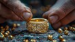 An aged goldsmith works on an unfinished 22 carat gold ring