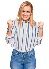 Wall Mural - Beautiful caucasian woman wearing casual clothes angry and mad raising fists frustrated and furious while shouting with anger. rage and aggressive concept.