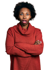 Wall Mural - African american woman with afro hair with arms crossed gesture afraid and shocked with surprise and amazed expression, fear and excited face.