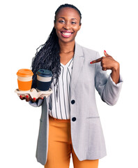 Canvas Print - Young african american woman wearing business clothes holding take away cup of coffee pointing finger to one self smiling happy and proud