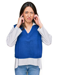 Canvas Print - Young hispanic girl wearing casual clothes covering ears with fingers with annoyed expression for the noise of loud music. deaf concept.