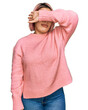 © Krakenimages.com - Hispanic woman with pink hair wearing casual winter sweater covering eyes with arm, looking serious and sad. sightless, hiding and rejection concept
