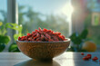Dried goji berries in a bowl on a table in a kitchen. Healthy superfood.