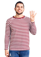 Wall Mural - Young handsome man wearing striped sweater showing and pointing up with fingers number four while smiling confident and happy.