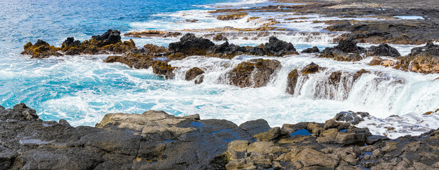 Wall Mural - Waves Washing Over The Rocky Volcanic Shoreline at Wawalili Beach, Wawaloli Beach Park, Hawaii Island, Hawaii, USA