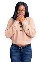 Poster - Young african american woman wearing casual clothes shocked covering mouth with hands for mistake. secret concept.